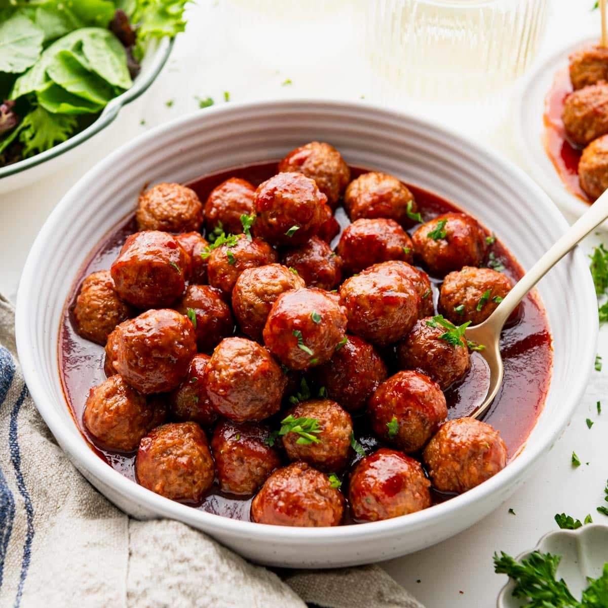 Square side shot of a bowl of crock pot grape jelly meatballs.