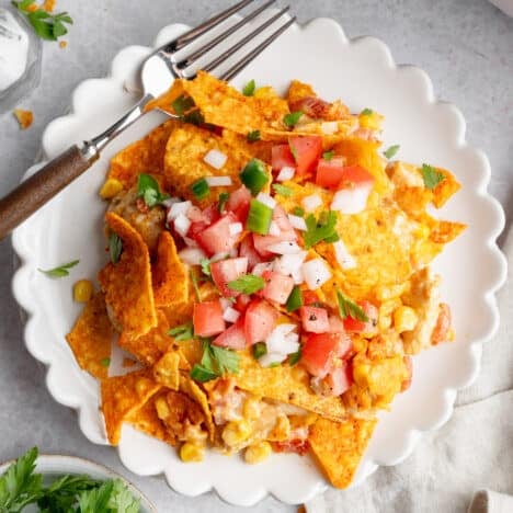 Square overhead shot of a Dorito chicken casserole served on a white plate.