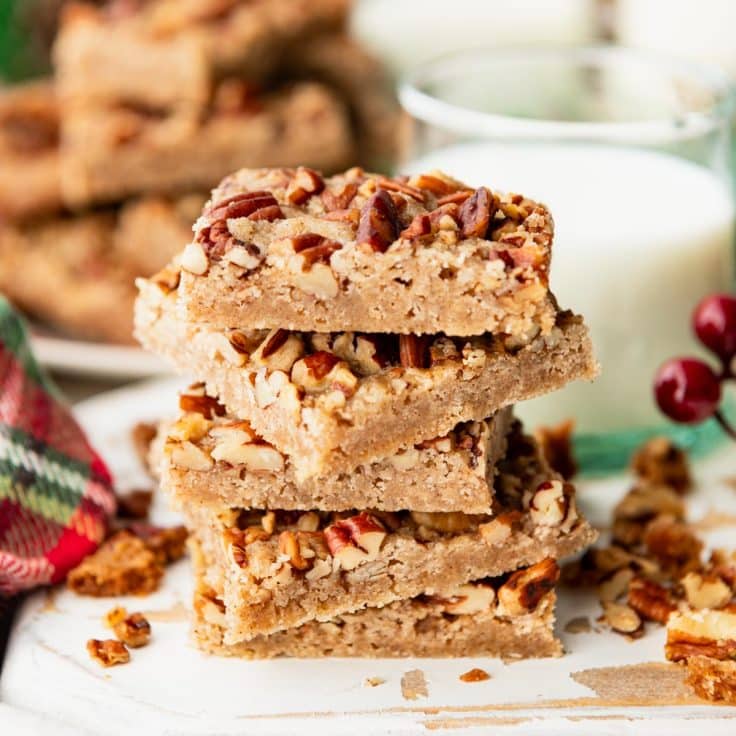 Square side shot of a stack of pecan cookie bars.