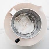 Sifting the dry ingredients for pecan bars.