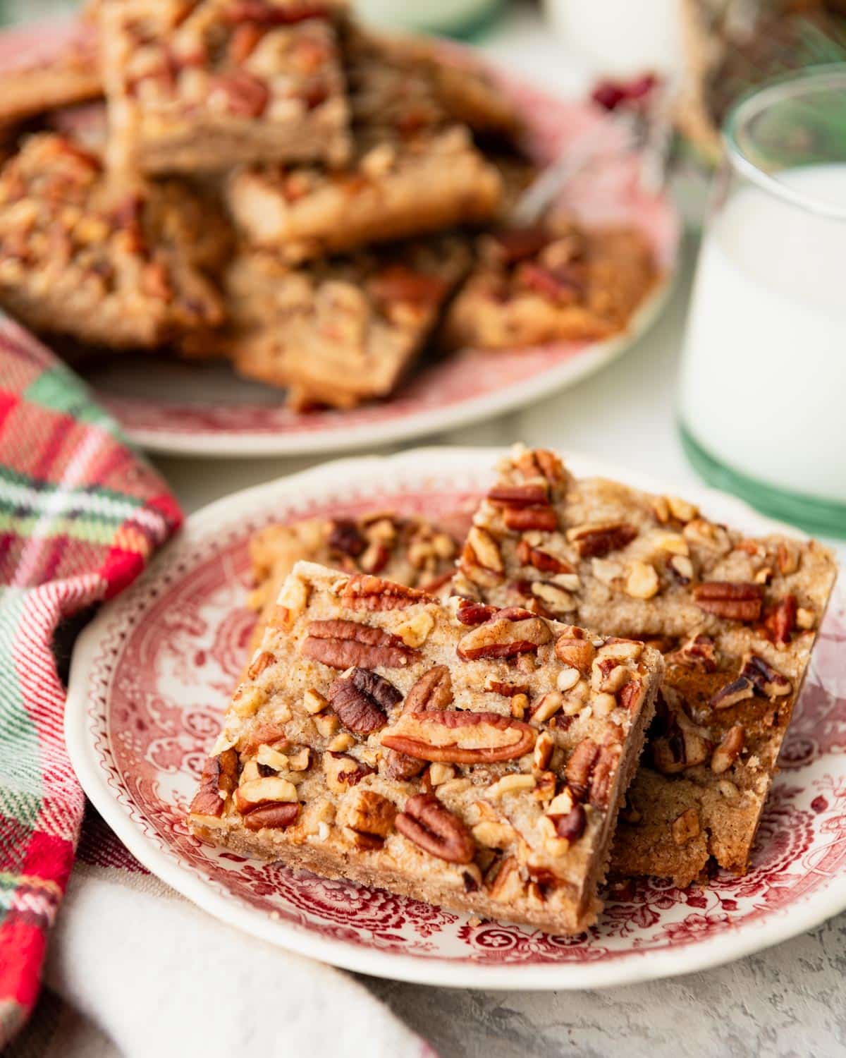 Side shot of cinnamon pecan cookie bars on a holiday table.
