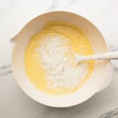 Folding the coconut into the cake batter.