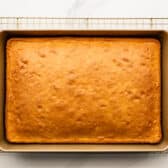 Baked coconut cake cooling on a wire rack.