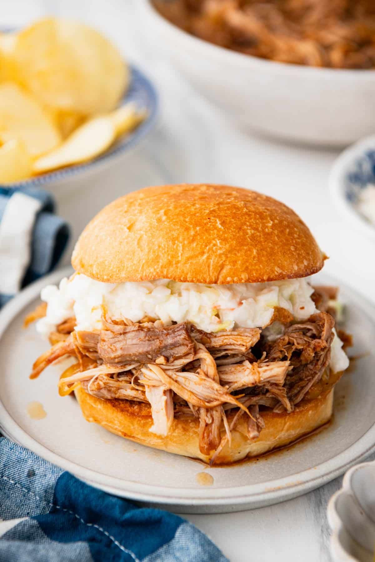 Side shot of a Dr. Pepper pulled pork sandwich with coleslaw.