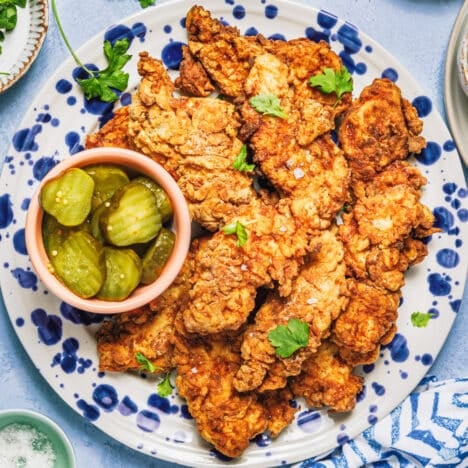 Square overhead shot of a platter of fried chicken tenders.
