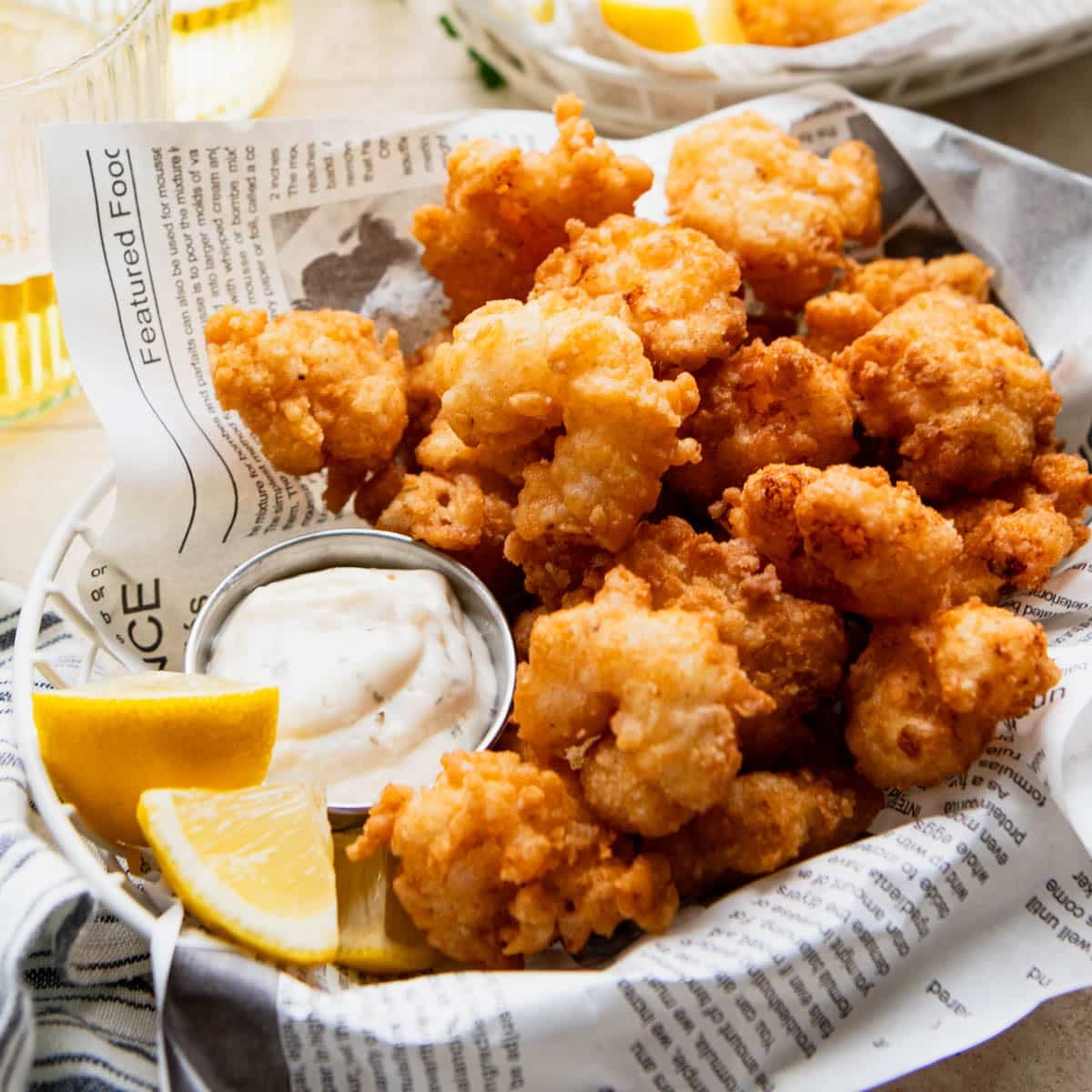 Square side shot of fried shrimp in a basket.