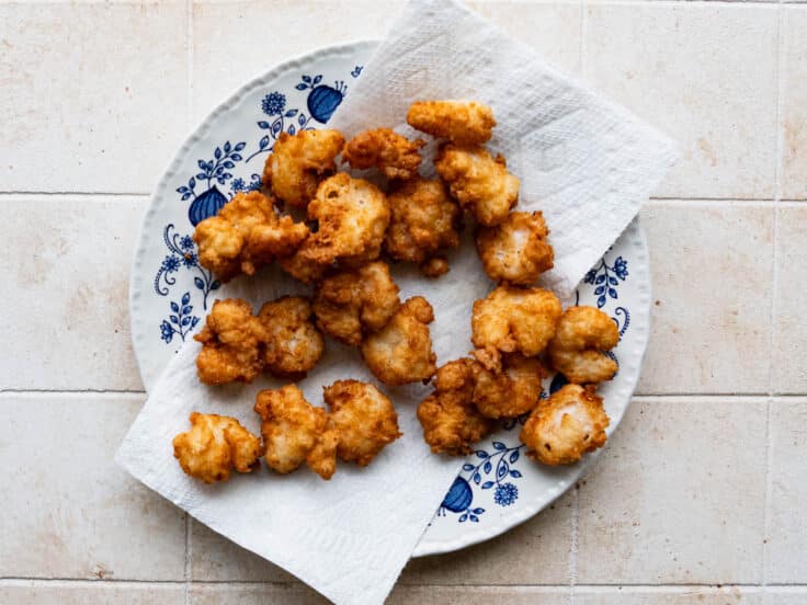 Draining fried shrimp on paper towels.