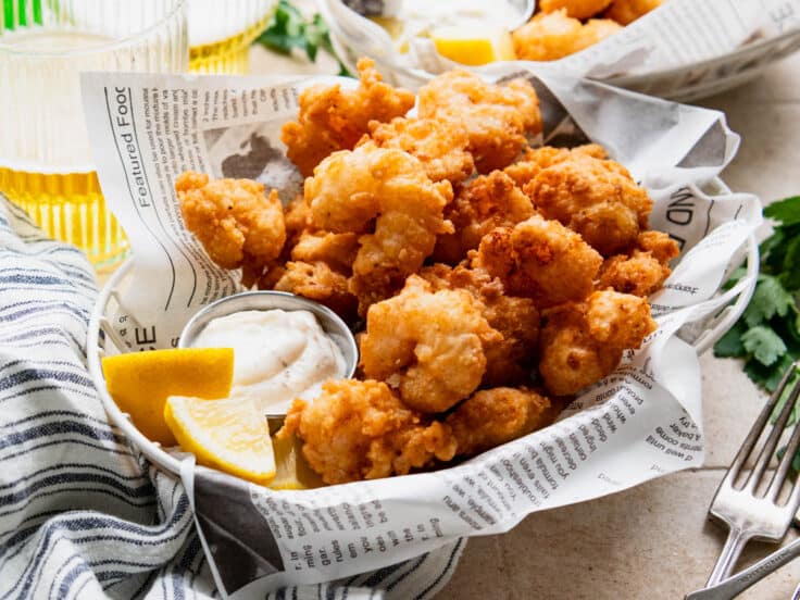 Horizontal side shot of two baskets of crispy Southern fried shrimp.