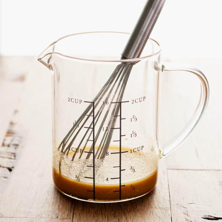 Whisking together a maple Dijon glaze for sheet pan salmon.