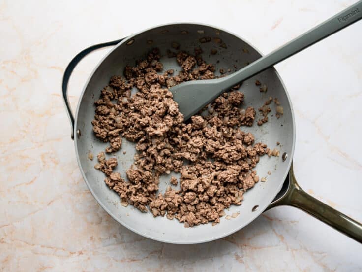 Browning ground beef in a skillet.