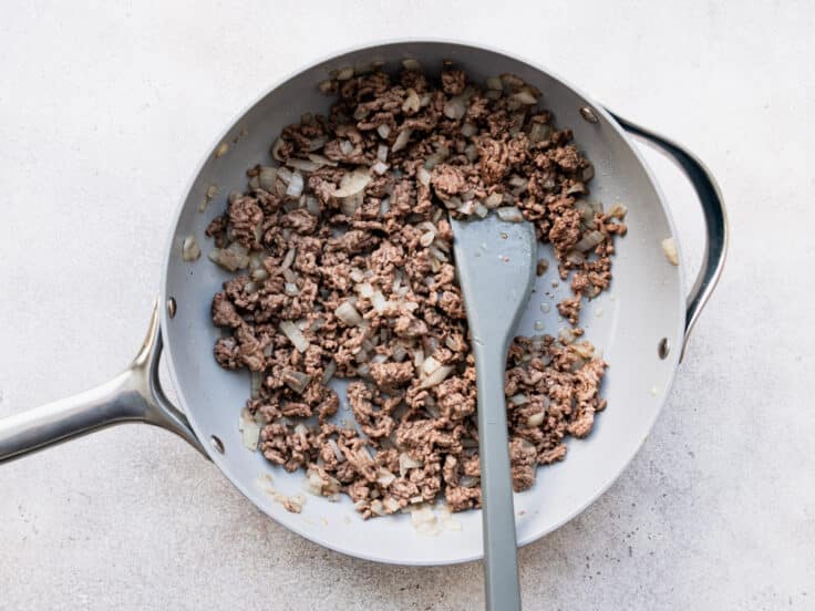 Browning ground beef in a skillet.