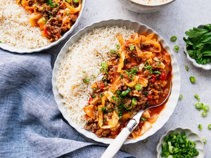 Horizontal overhead shot of unstuffed cabbage rolls served with rice.