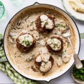 Square overhead shot of a pan of hamburger steak with gravy.