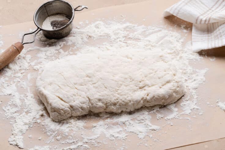 Patting out the dough.