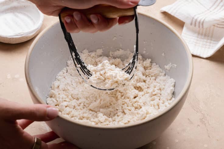 Cutting sour cream into the bisquick.