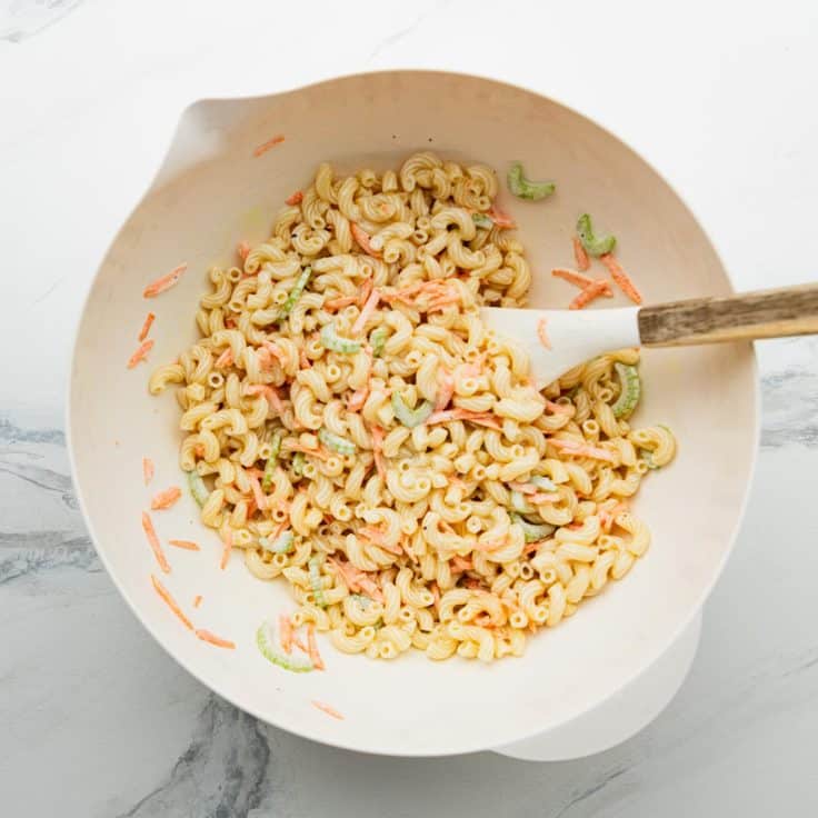 Process shot showing how to make Hawaiian macaroni salad.