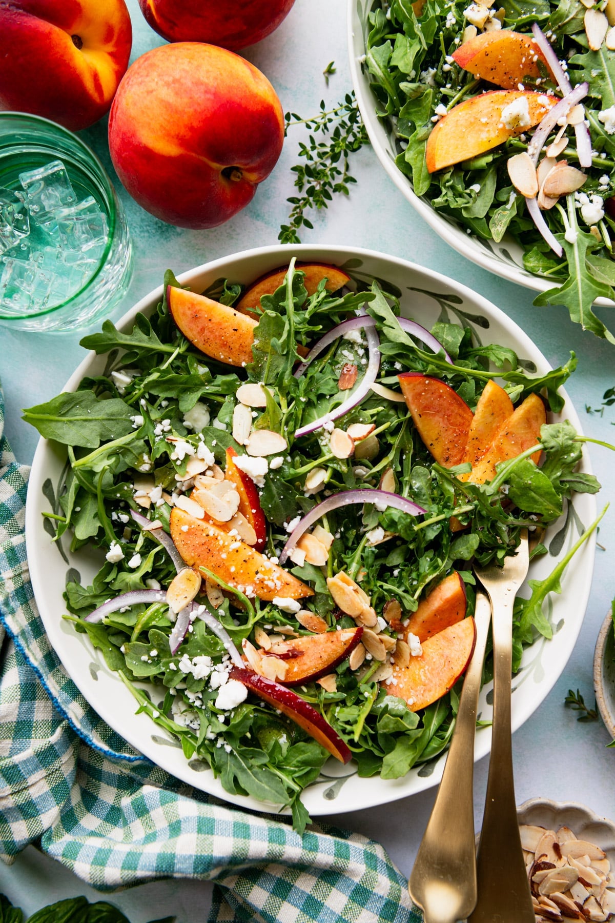 Overhead shot of a peach salad on a green table with homemade vinaigrette.
