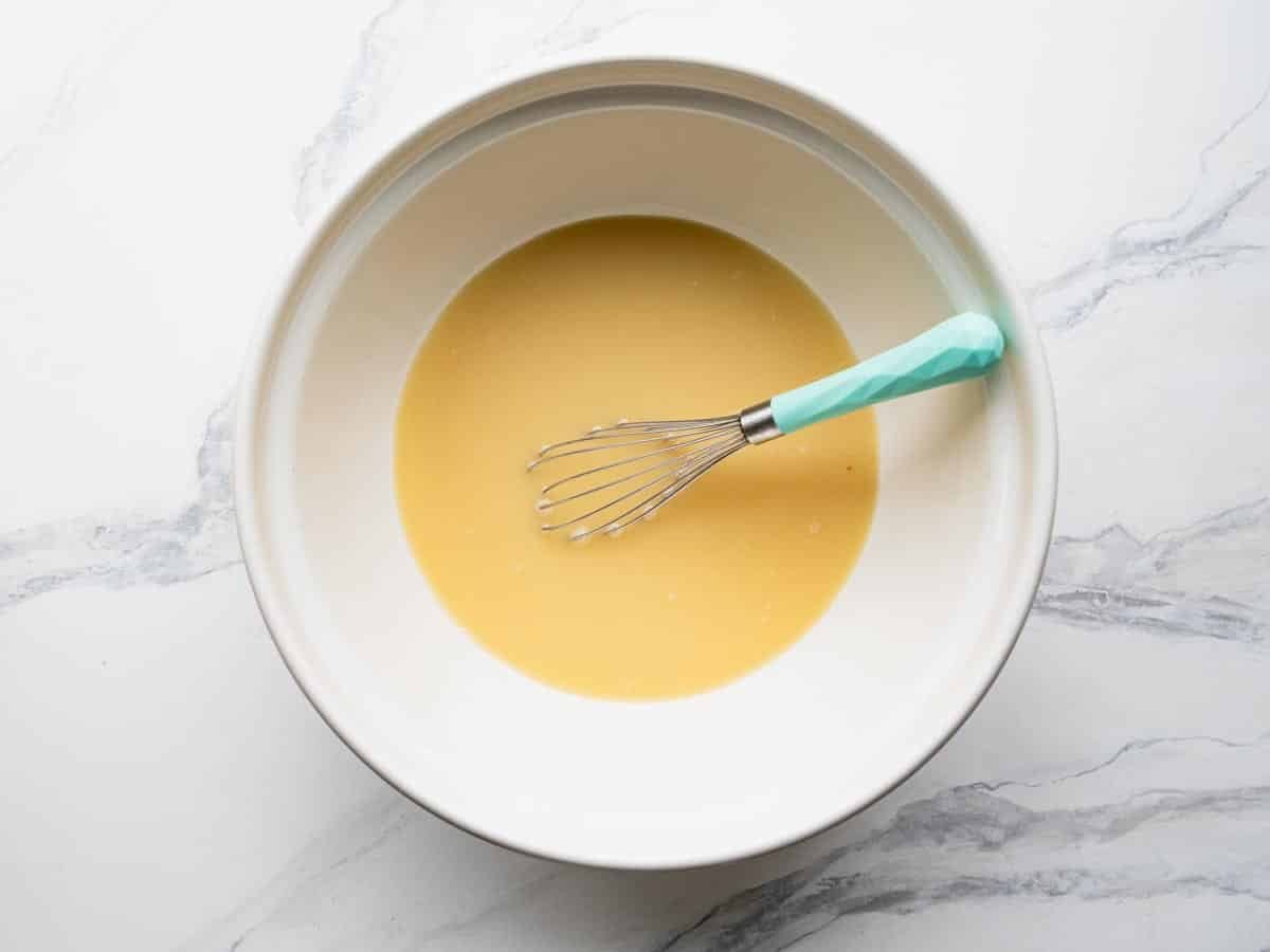 Whisking eggs and broth for cornbread dressing.