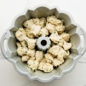 Assembled pull apart garlic bread in a bundt pan before baking.