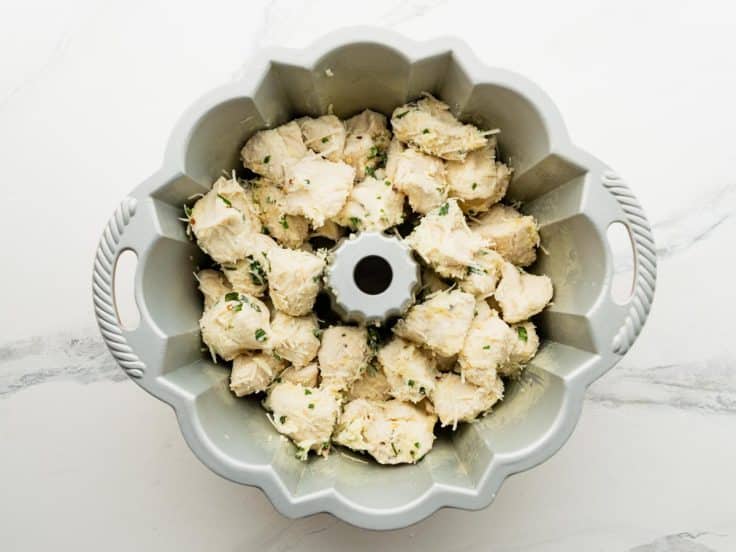 Assembled pull apart garlic bread in a bundt pan before baking.