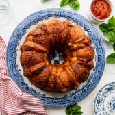 Horizontal overhead image of a blue and white platter with a pull apart garlic bread.
