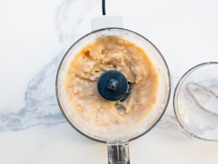 Pureed white beans in a small food processor.