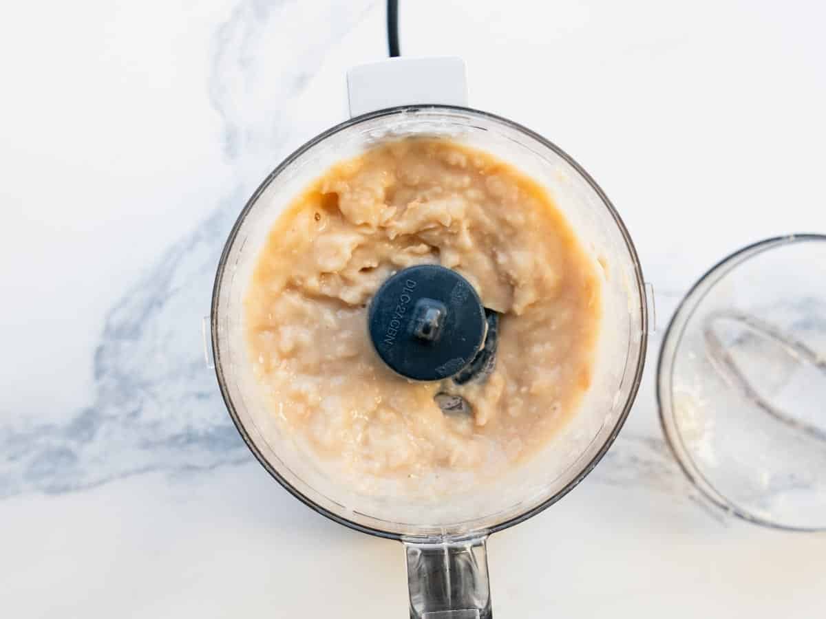 Pureed white beans in a small food processor.