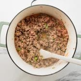 Cooking ground turkey in a pot.