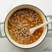 Simmering white bean turkey chili in a Dutch oven.