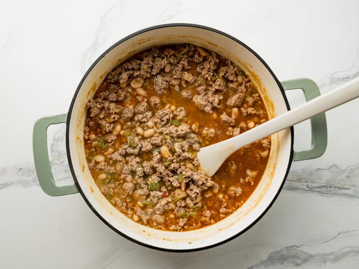 Simmering white bean turkey chili in a Dutch oven.