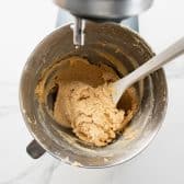 Cookie dough in a stand mixing bowl.