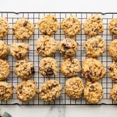Overhead shot of cranberry oatmeal cookies cooling on a wire rack.