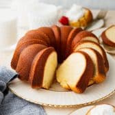 Square shot of a buttermilk pound cake on a white and gold plate.