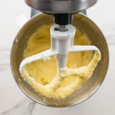 Mixing eggs into creamed butter and sugar.