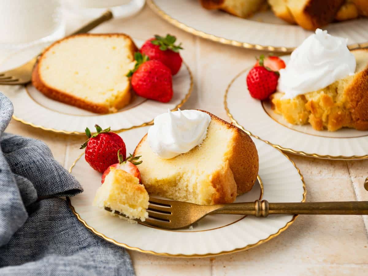 Horizontal side shot of a slice of buttermilk pound cake with a bite on a fork.
