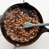 Adding the seasoning to the meat mixture.