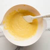 Stirring together a box of Jiffy corn muffin mix.