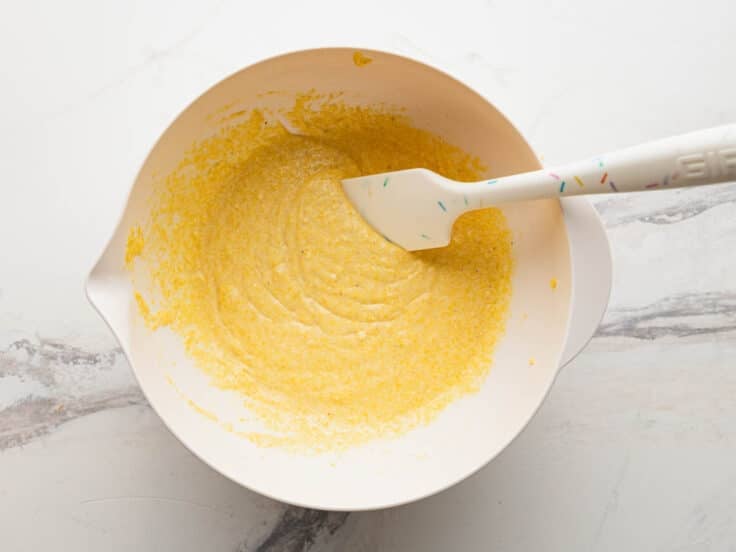 Stirring together a box of Jiffy corn muffin mix.