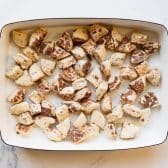 Cut cinnamon rolls in a baking dish.