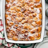 Square overhead shot of a pan of baked cinnamon roll breakfast casserole.