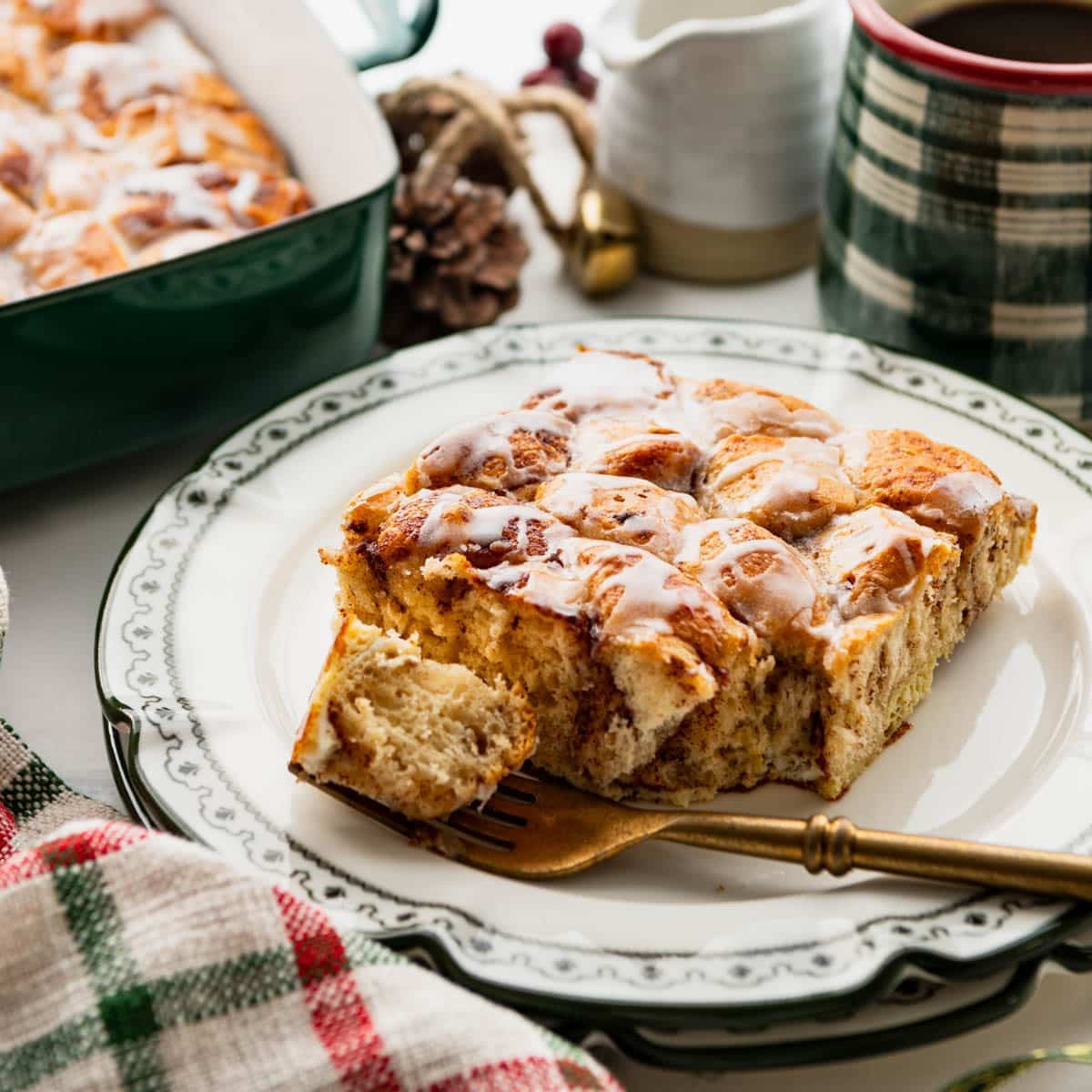 Square side shot of a piece of Pillsbury cinnamon roll casserole on a table.