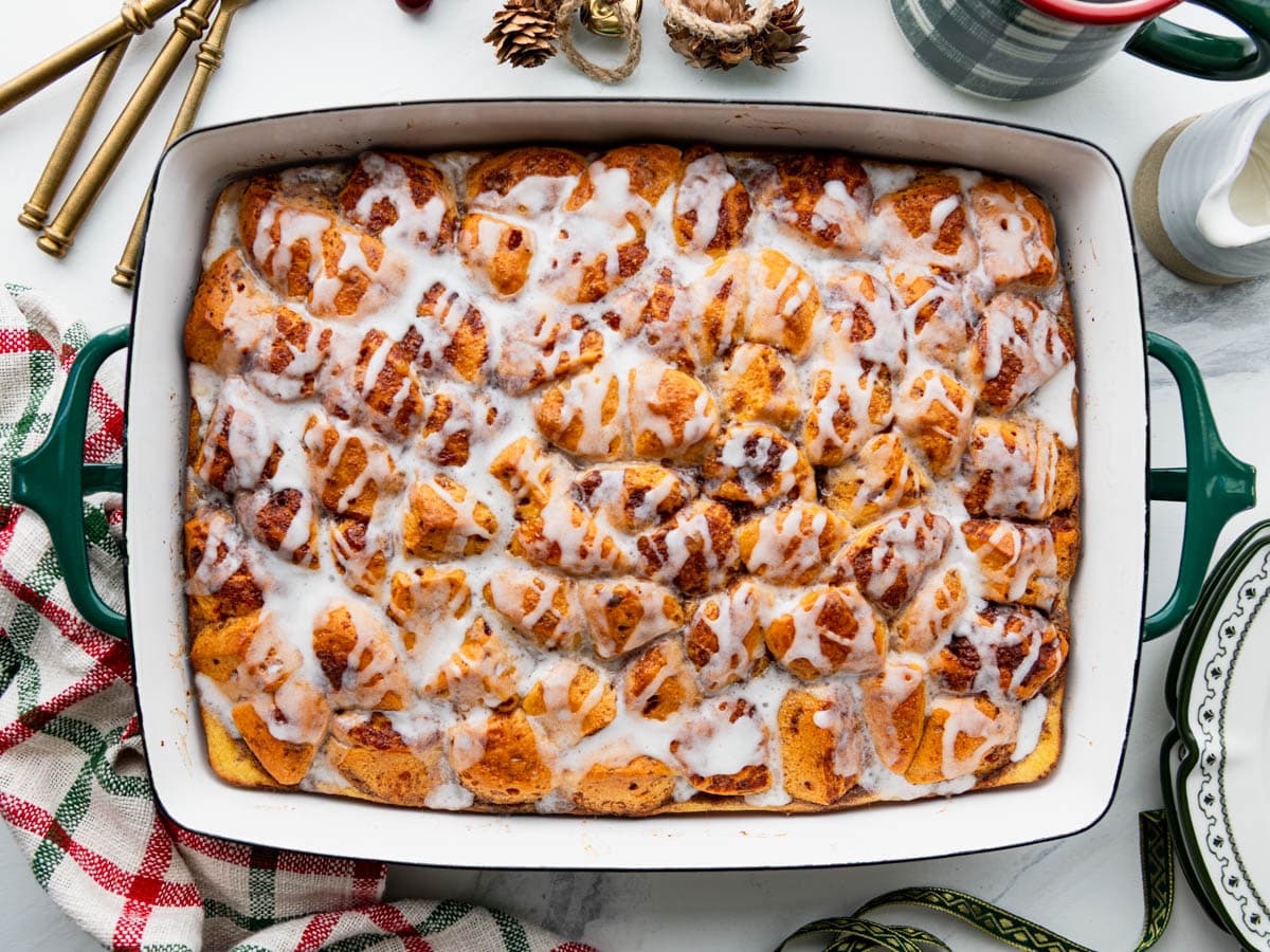 Horizontal overhead image of a finished Pillsbury cinnamon roll casserole on a holiday table.