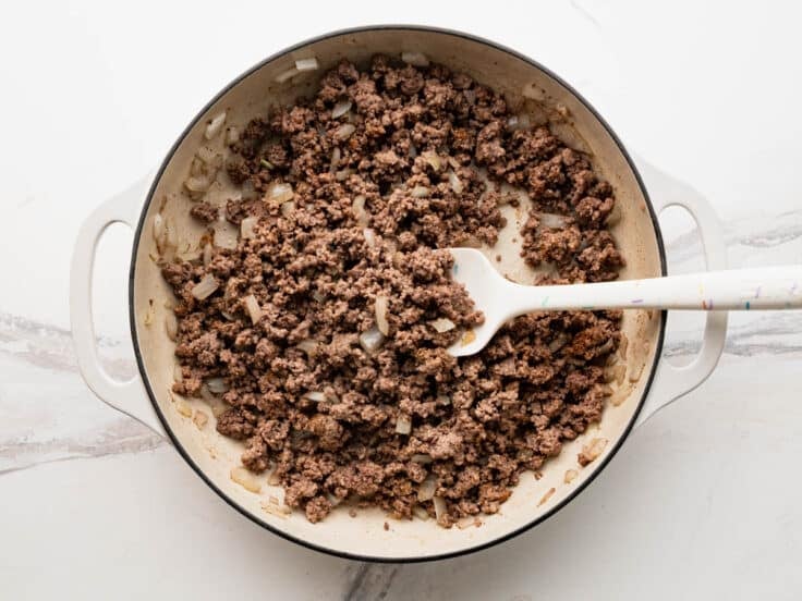 Browning ground beef in a skillet.