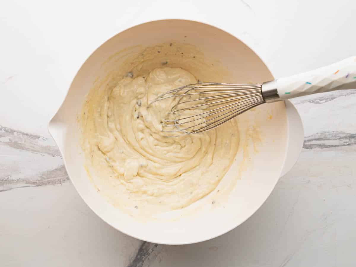 Whisking together the creamy sauce.