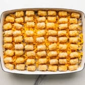 Cowboy casserole with tater tots on top before baking.