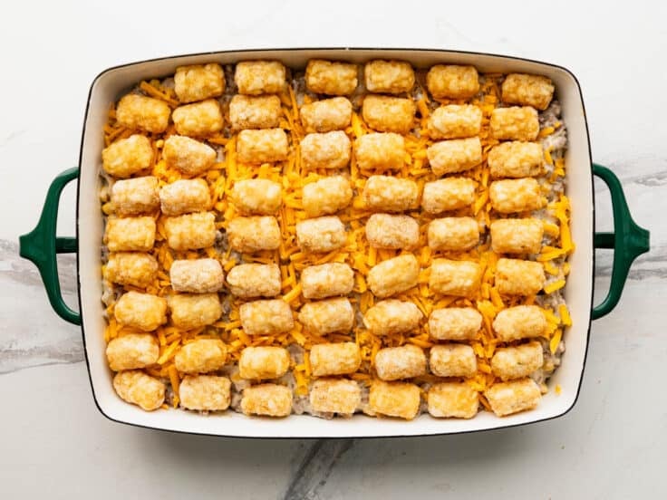 Cowboy casserole with tater tots on top before baking.
