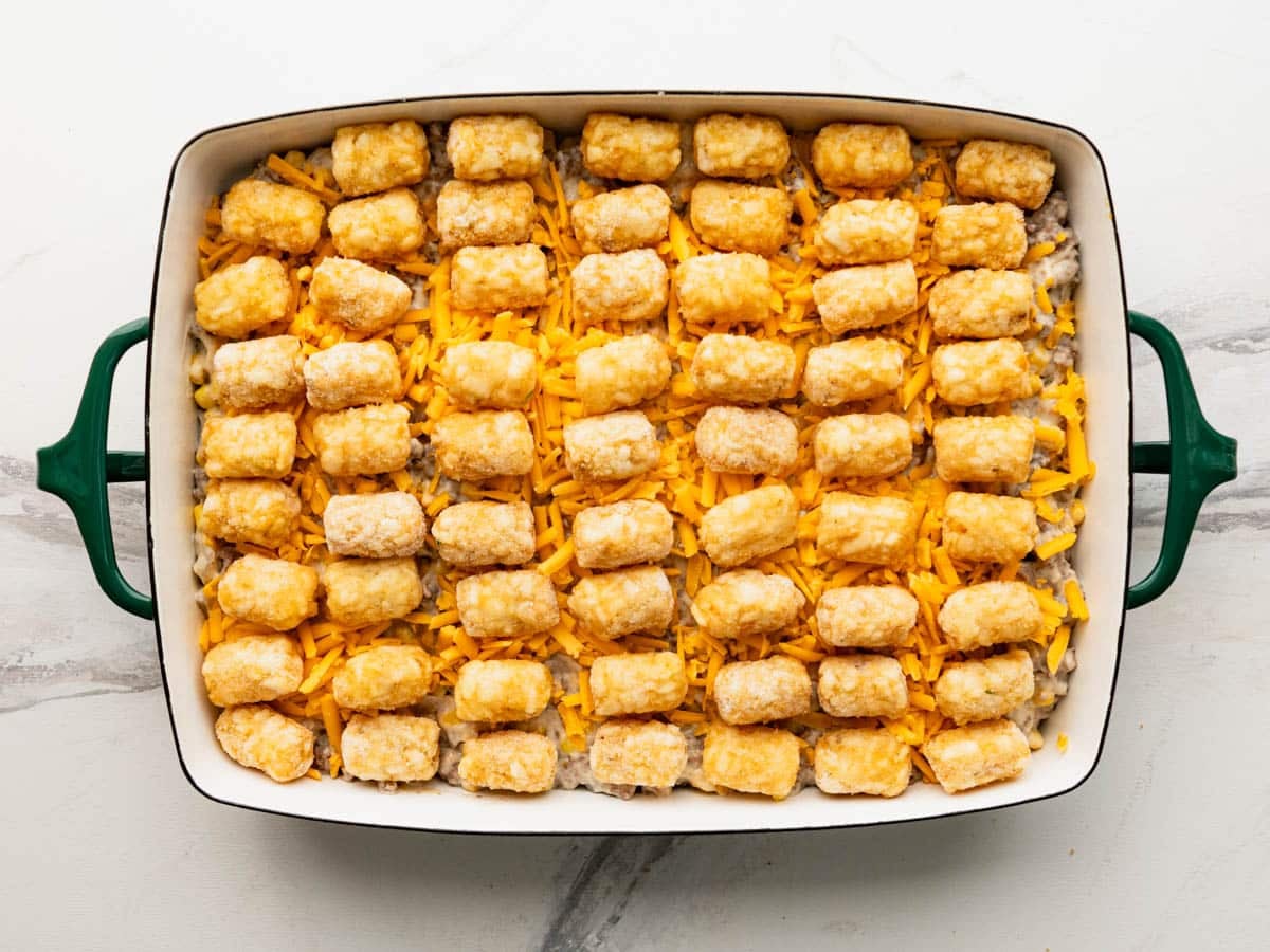 Cowboy casserole with tater tots on top before baking.