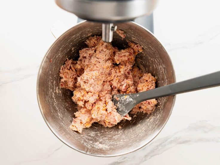 Cream cheese sausage ball mixture in a stand mixer bowl.