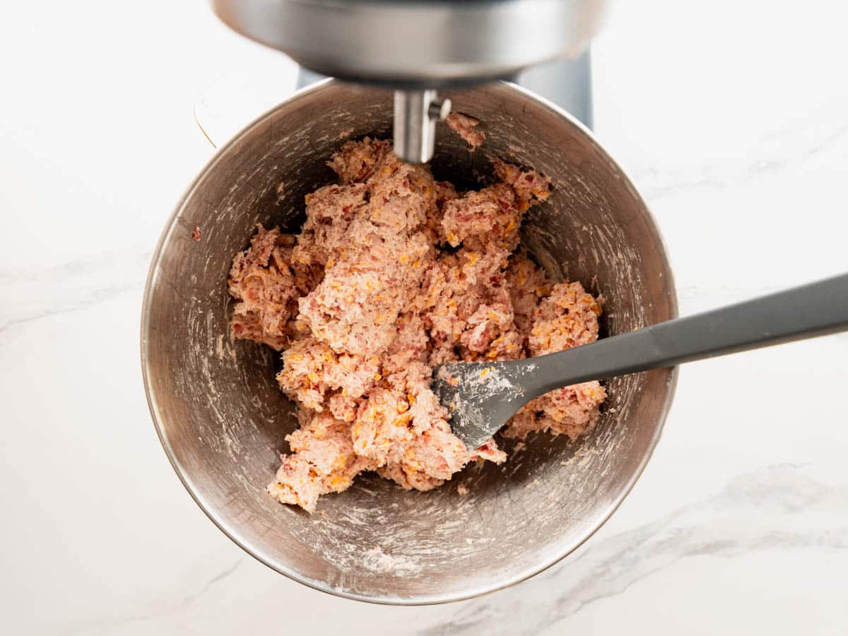 Cream cheese sausage ball mixture in a stand mixer bowl.