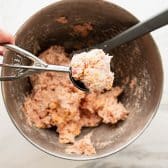 Scooping the sausage ball mixture.